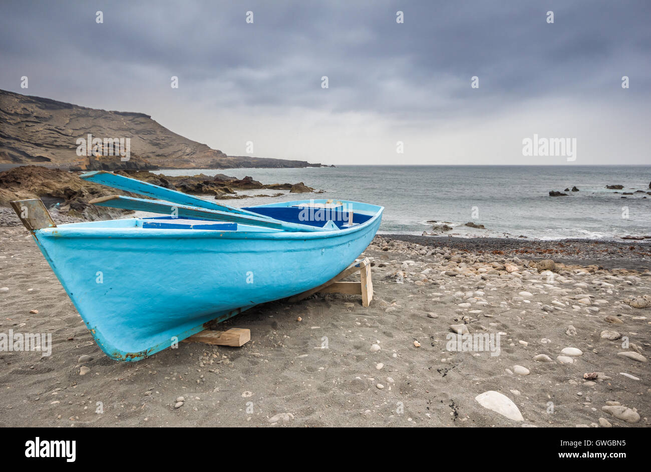 boat moored on the beach before the storm Stock Photo