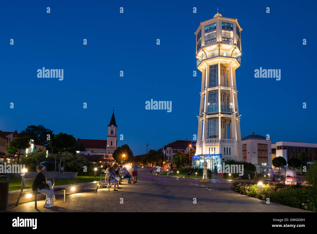 SIOFOK, HUNGARY - AUGUST 24, 2016: Old wooden water tower on main square of city Siofok with night illumination. Stock Photo