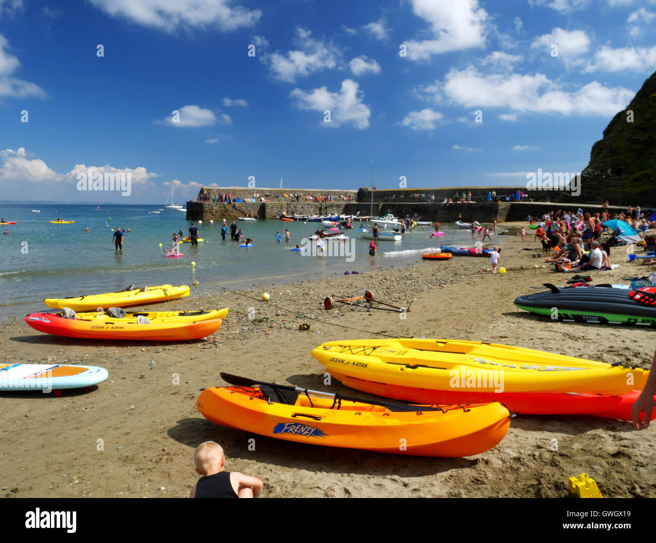 Yellow kayaks on a sunny Cornish beach. Stock Photo