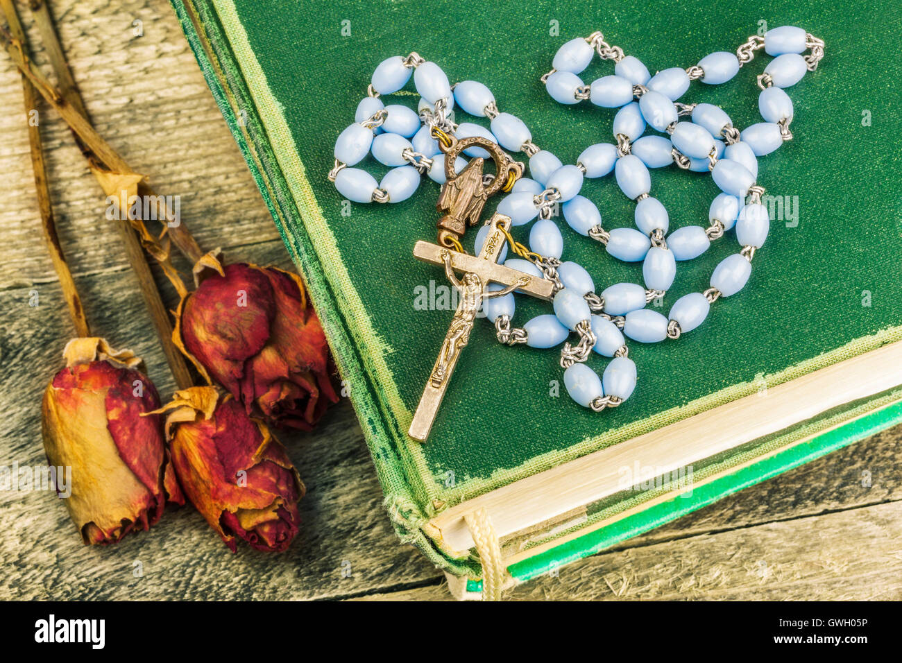 Rosary, bible and dried roses on the table Stock Photo Alamy