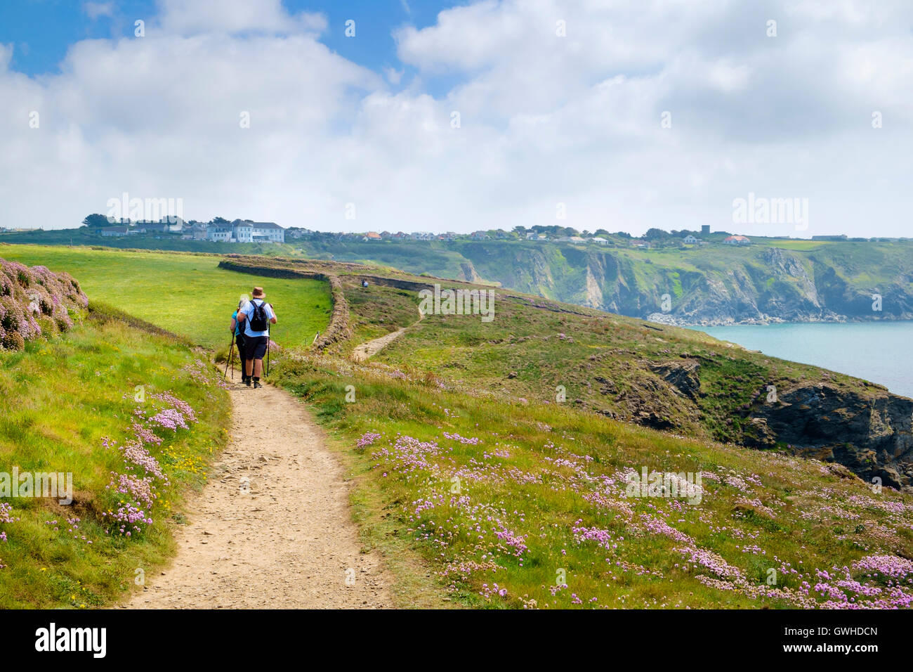 Walkers hiking on the Cornwall coast South West Coast Path UK, Lizard Peninsula, Cornwall, England, UK Stock Photo