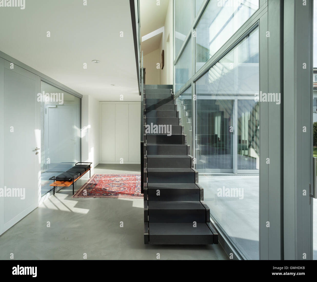 Interior of a modern house, hall with iron staircase Stock Photo