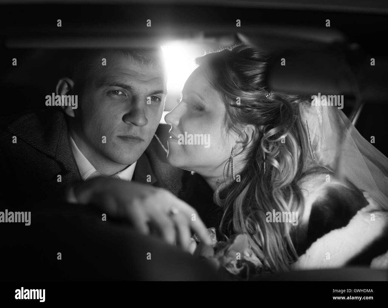 Young couple kissing, black and white photo Stock Photo Alamy
