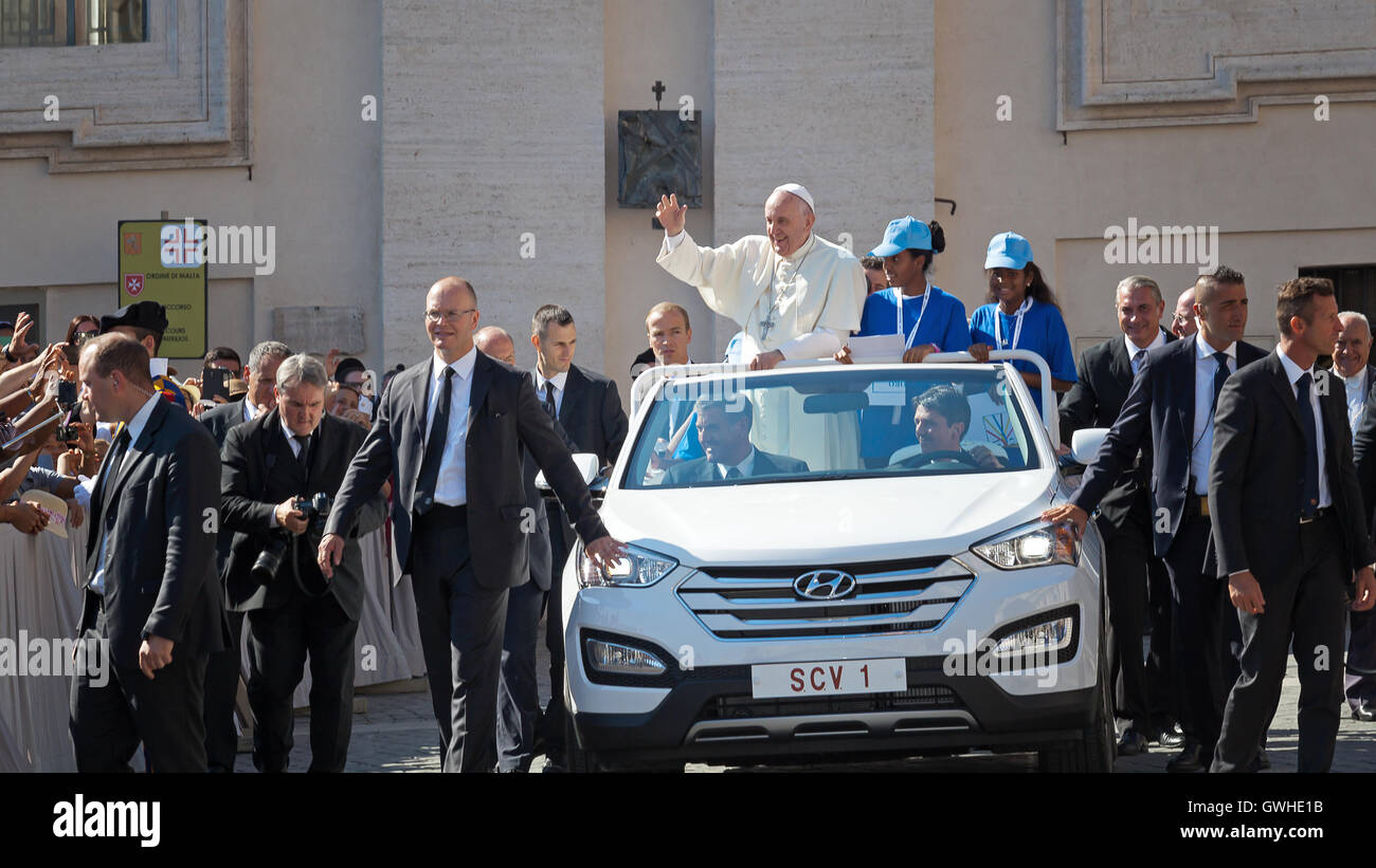 Vatican State - September 3, 2016: Pope Francis on the new convertible car, waving to the crowd of faithful gathered in St. Pete Stock Photo