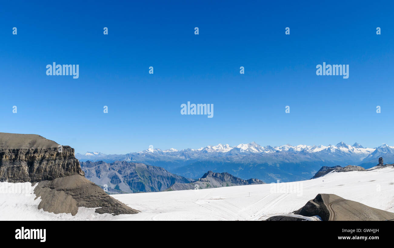 Snow capped mountain landscape with big clear blue sky Stock Photo - Alamy