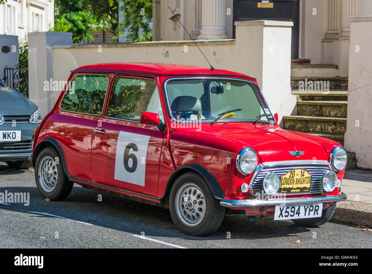 Classic red 2-door mini with number 6 Stock Photo