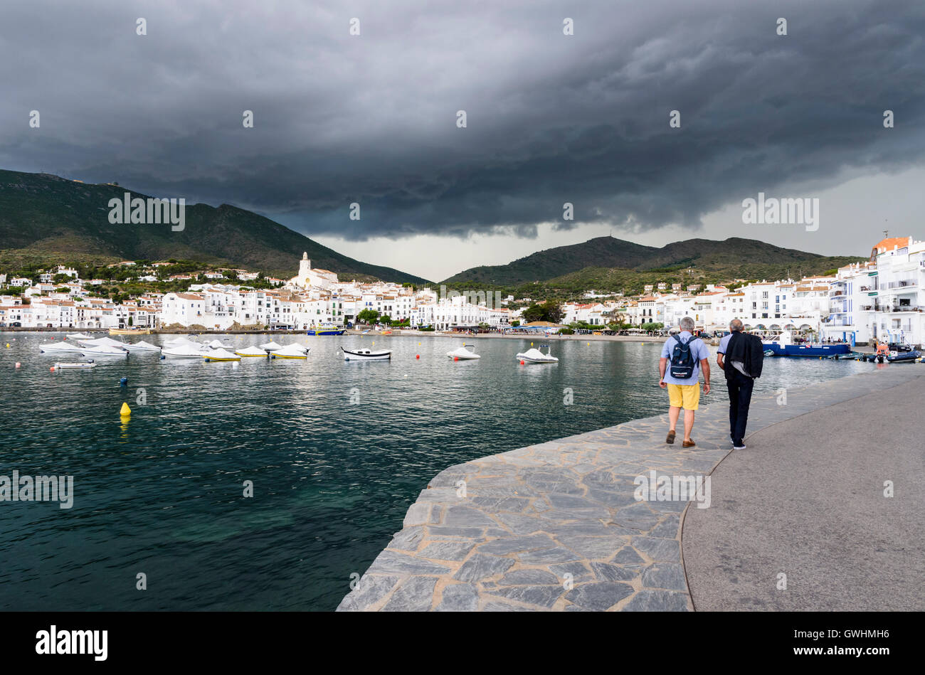 Dark storm clouds gather over the picturesque white town of Cadaques on the Costa Brava, Spain Stock Photo