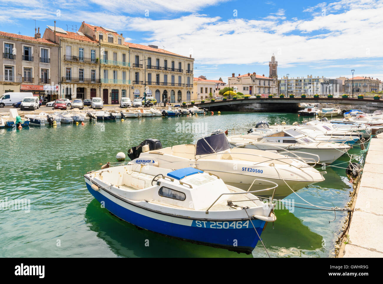 Small boats moored along Quai de Bosc on the Canal Royal which runs through the middle of Sète, Hérault, France Stock Photo