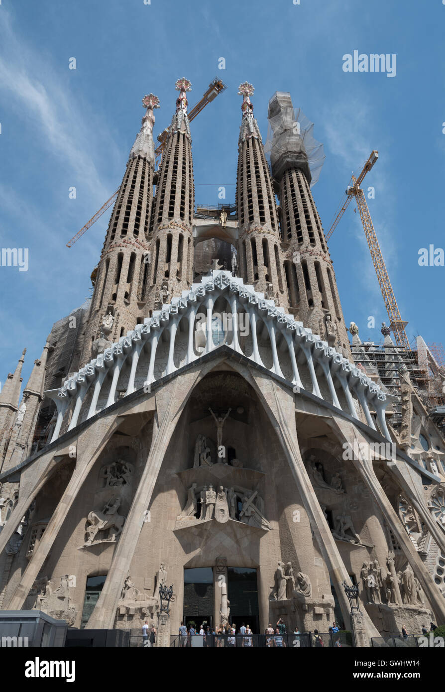 The iconic and unfinished stunning Gaudi Cathedral, The Sagrada Familia, Barcelona.  Blue sky and cranes. Stock Photo