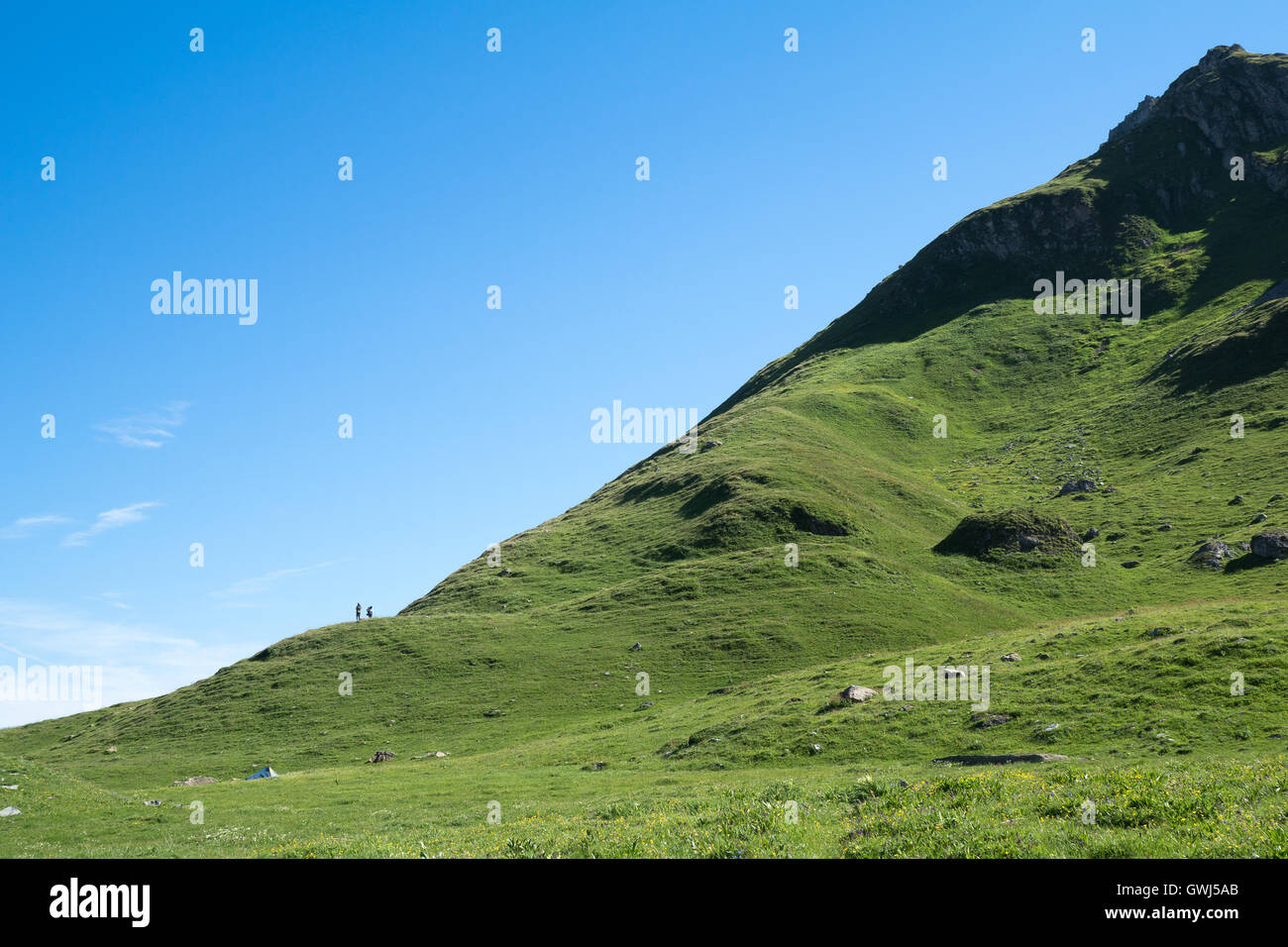 2 people watching the mountains at the foot of a hill, Beaufortin, France, Alpes Stock Photo