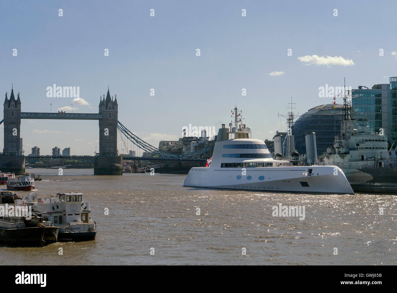Motor yacht 'A' moored next to HMS Belfast on the Thames in the City of London. The super yacht was designed by Philippe Starck Stock Photo