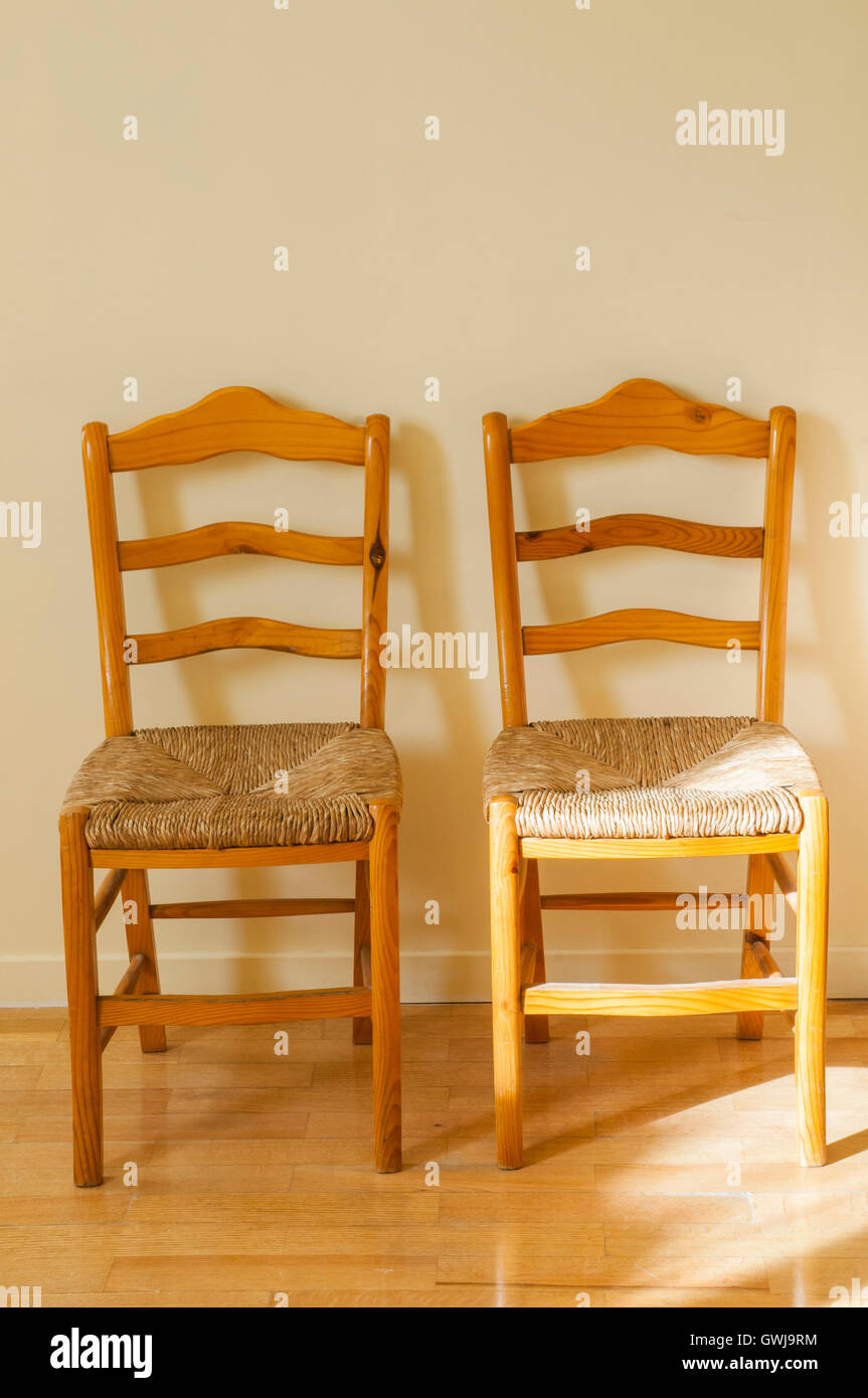 Two wooden chairs with wickerwork seats Stock Photo Alamy