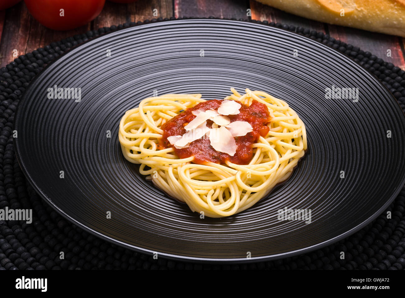 I love pasta, Spaghetti heart with marinara on a black dish Stock Photo