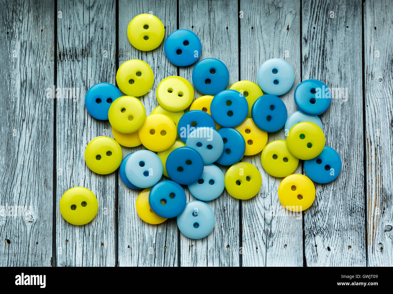 Pile of colorful buttons on wooden background Stock Photo - Alamy