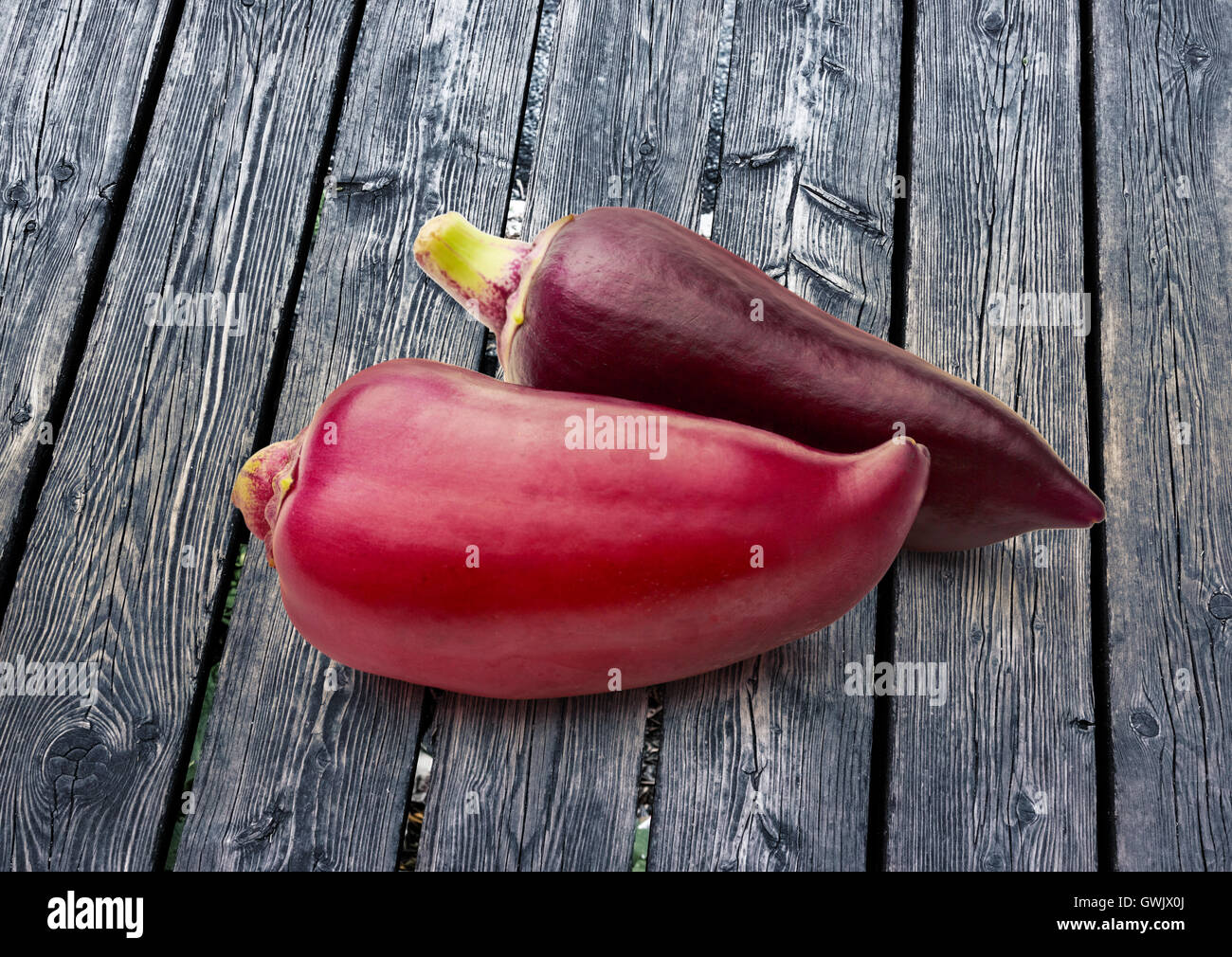 Red paprika pepper on wooden background closeup Stock Photo