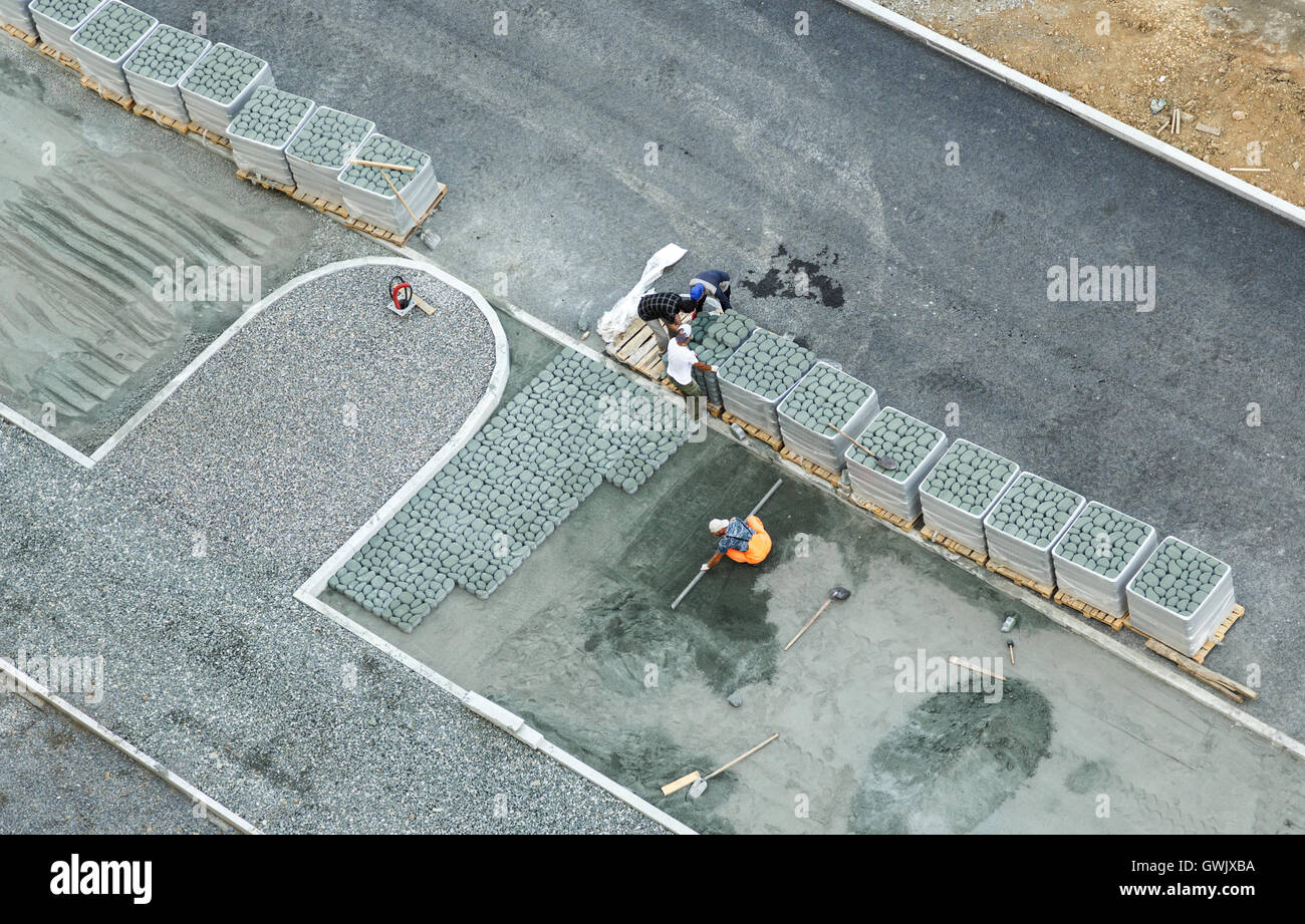 Workers constructing pavement with tile view from above Stock Photo