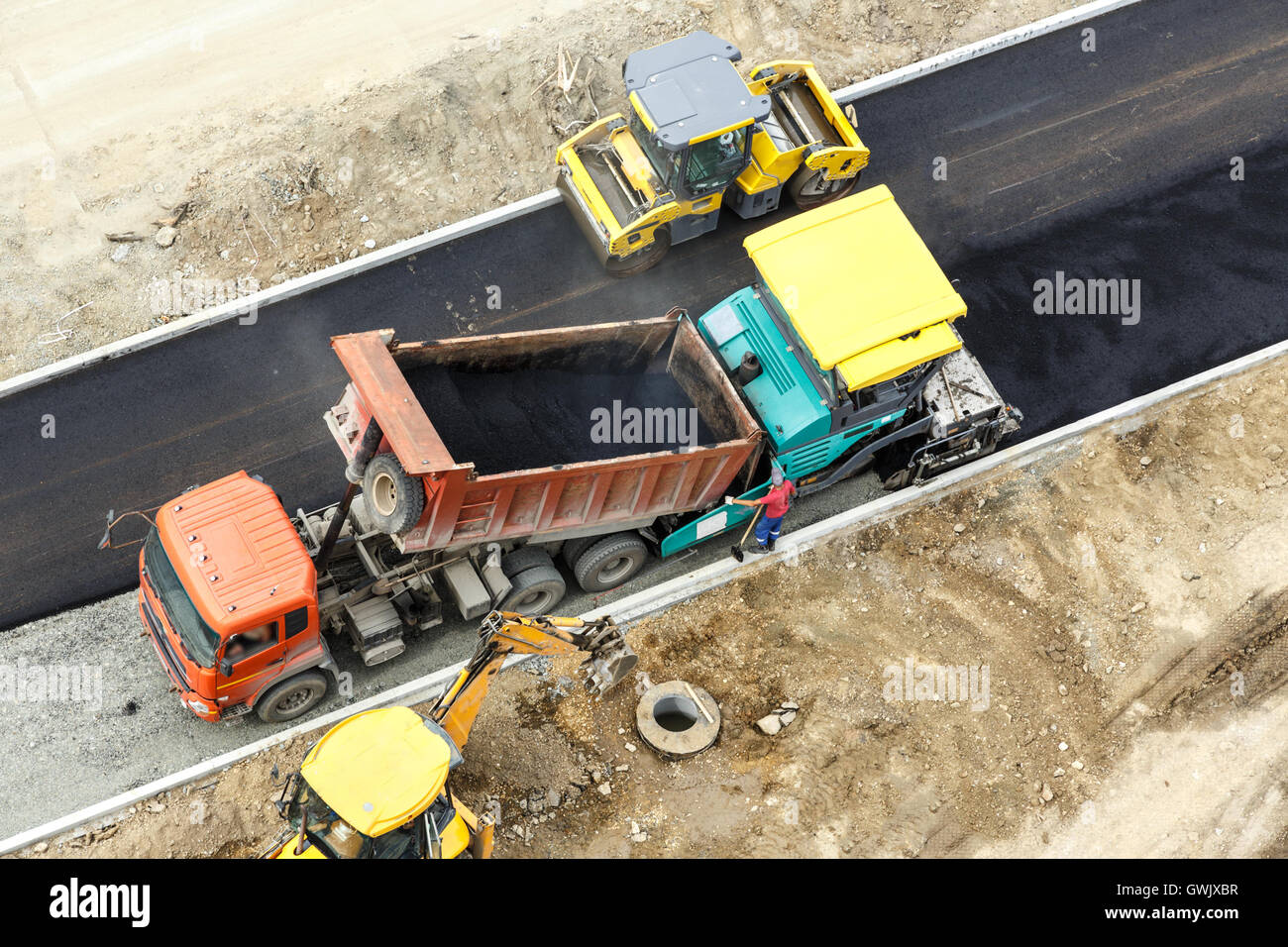 Workers constructing road with asphalt view from above Stock Photo