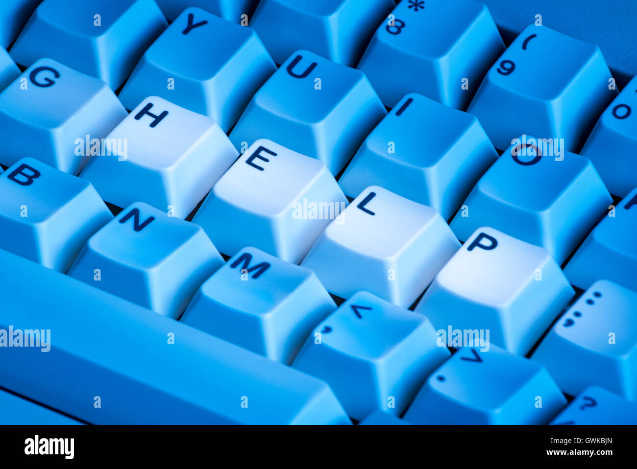 Keyboard with highlighted keys, spelling the word HELP Stock Photo