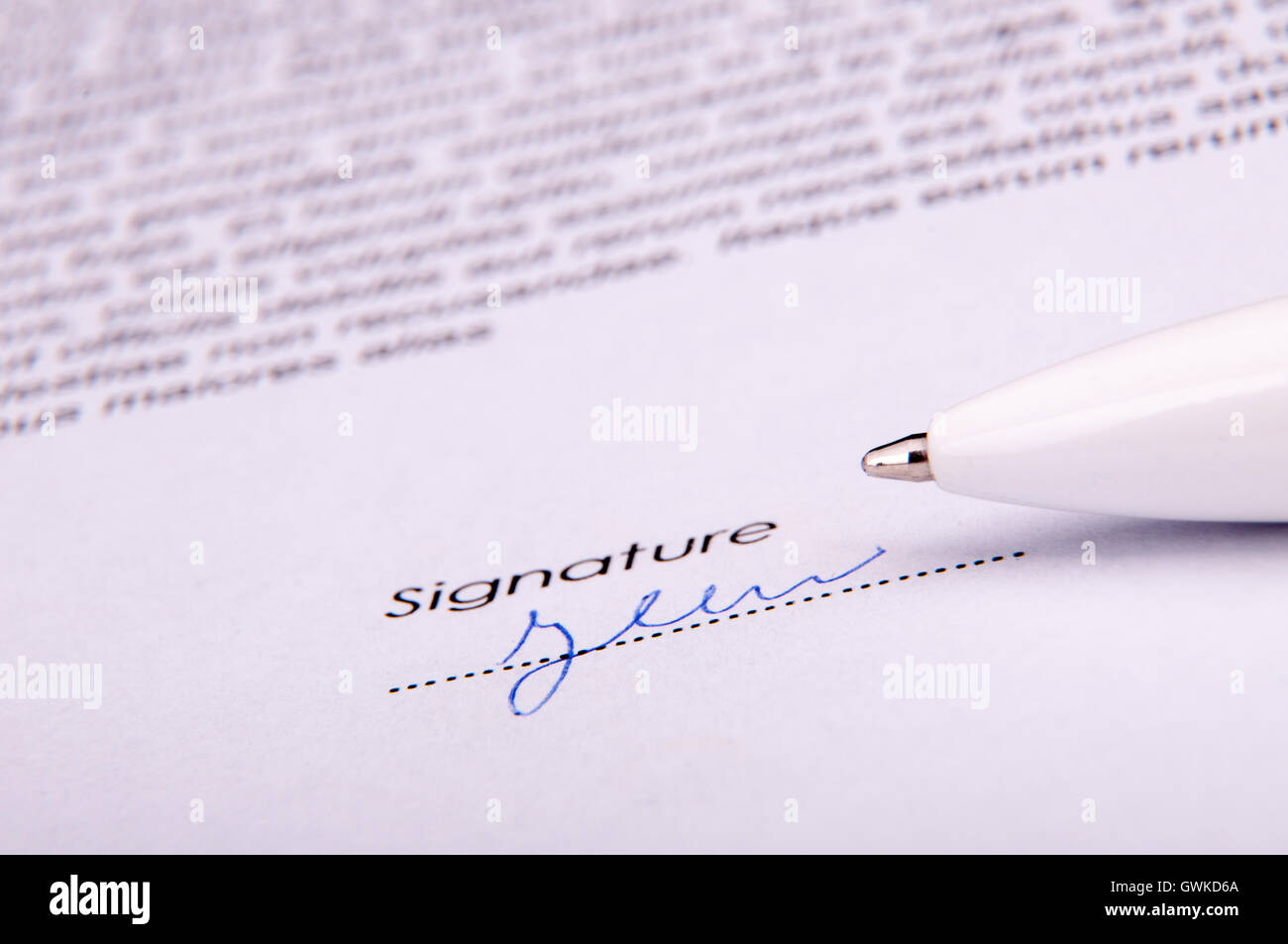 Signature over agreement Stock Photo
