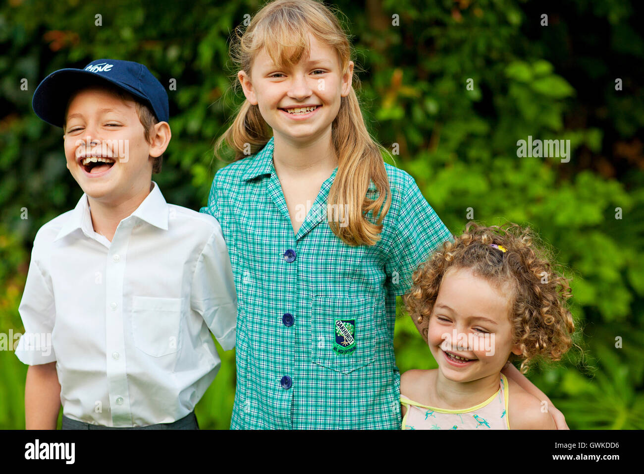 Three smiling and laughing school children Stock Photo