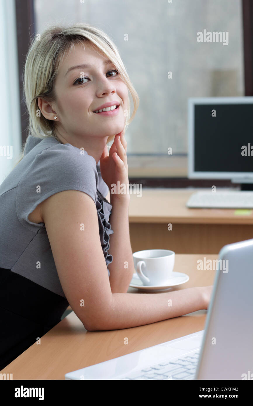 Young pretty business woman with notebook in the office Stock Photo - Alamy