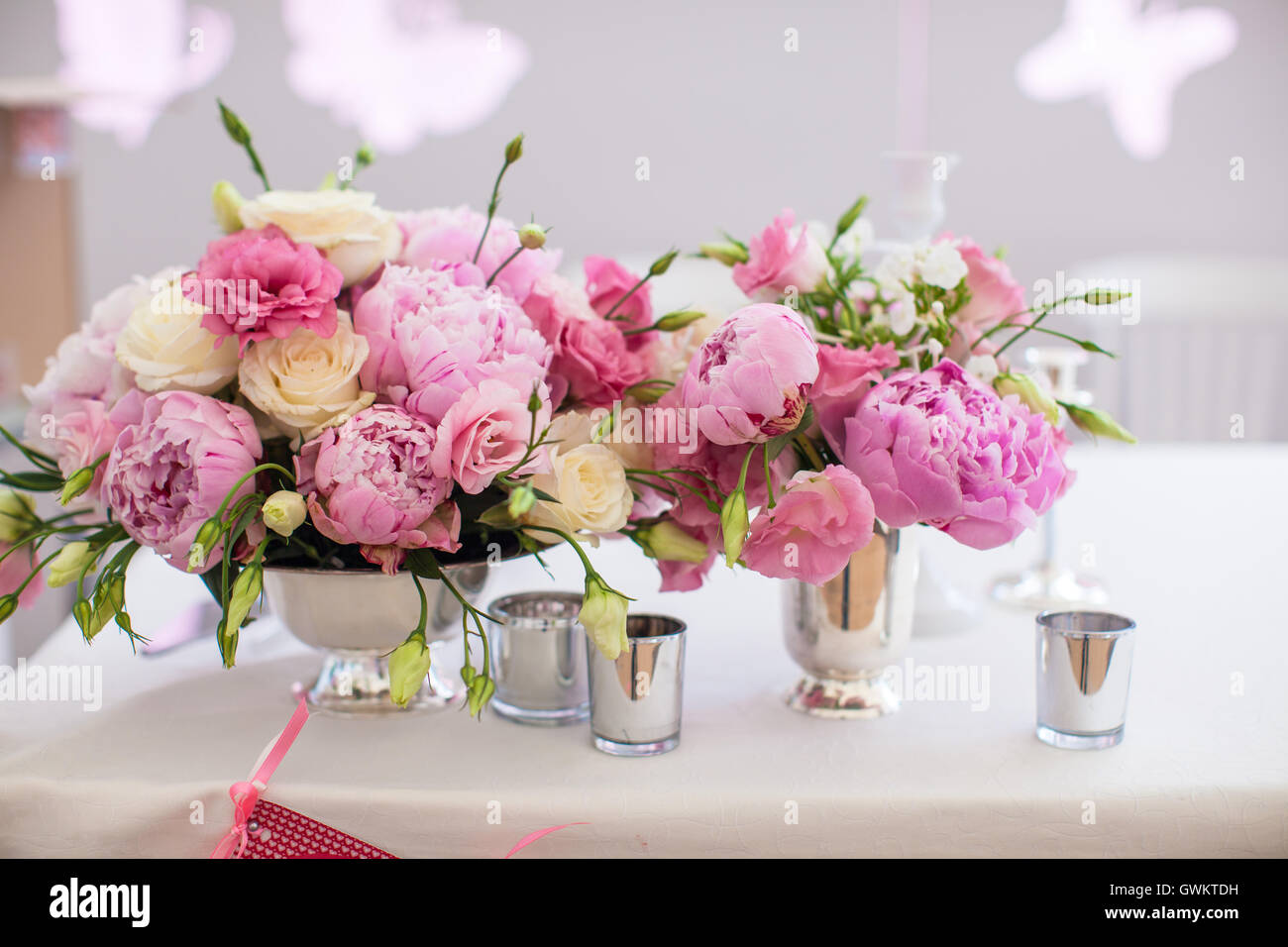 Beautiful bright bouquet of peony on the wedding table in vase Stock Photo