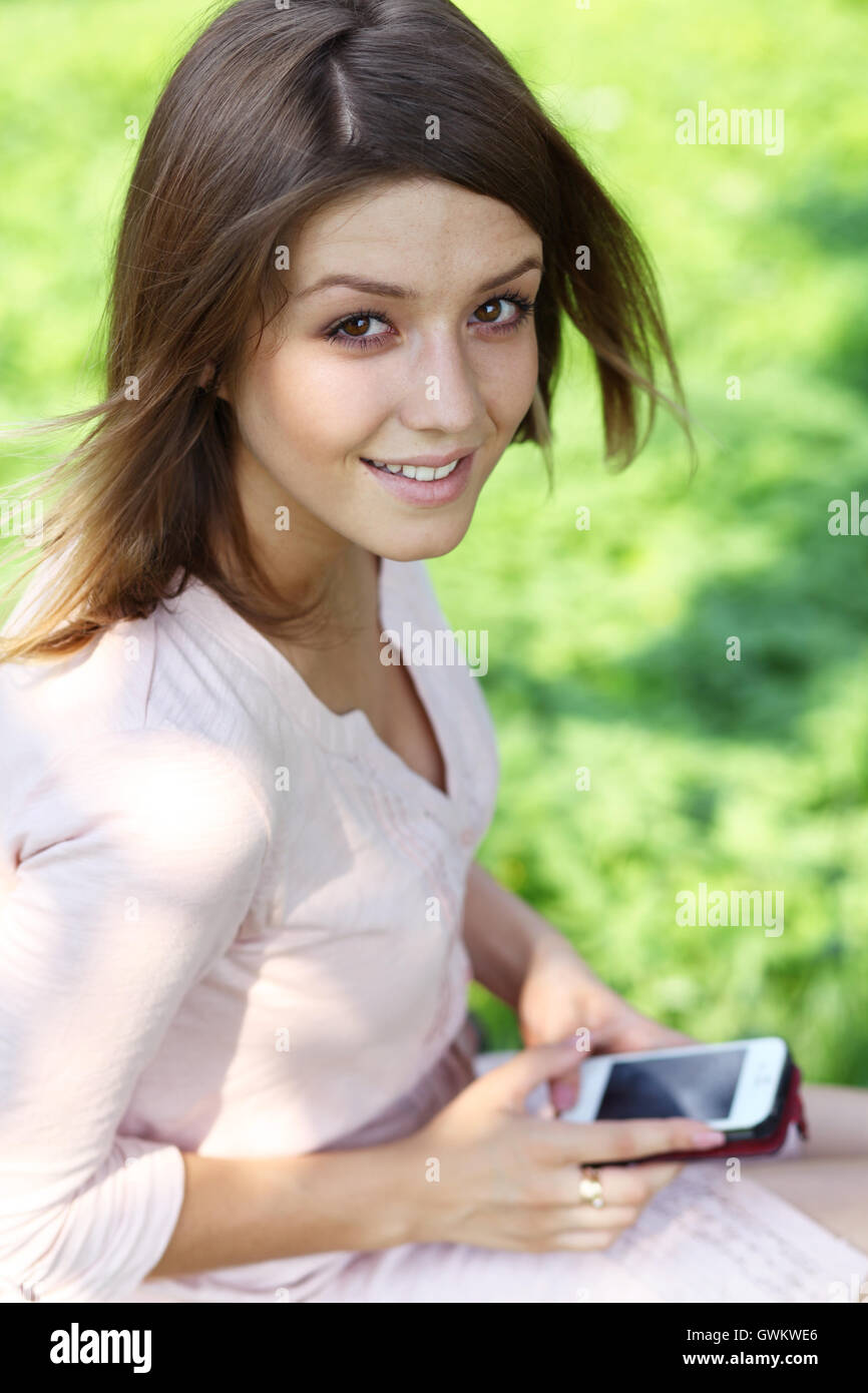 Young woman sitting in the summer park Stock Photo - Alamy
