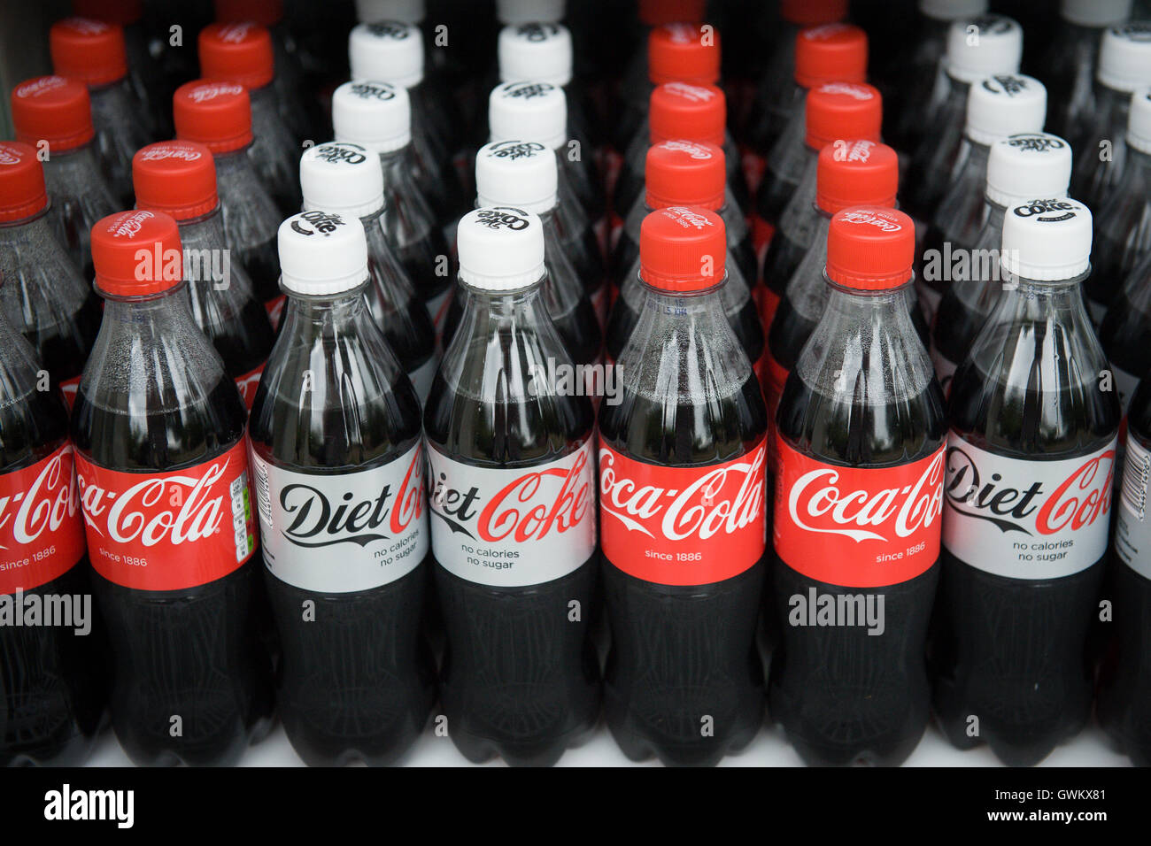 Coke and diet coke bottles on supermarket shelves in UK, which has recently introduced a sugar tax on drinks, which contribute to childhood obesity. Stock Photo