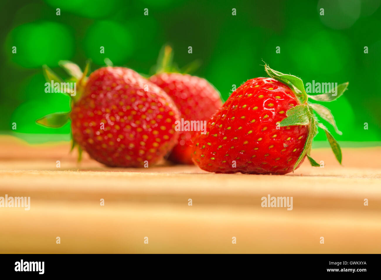 few berries fresh strawberries on a blurred background Stock Photo - Alamy