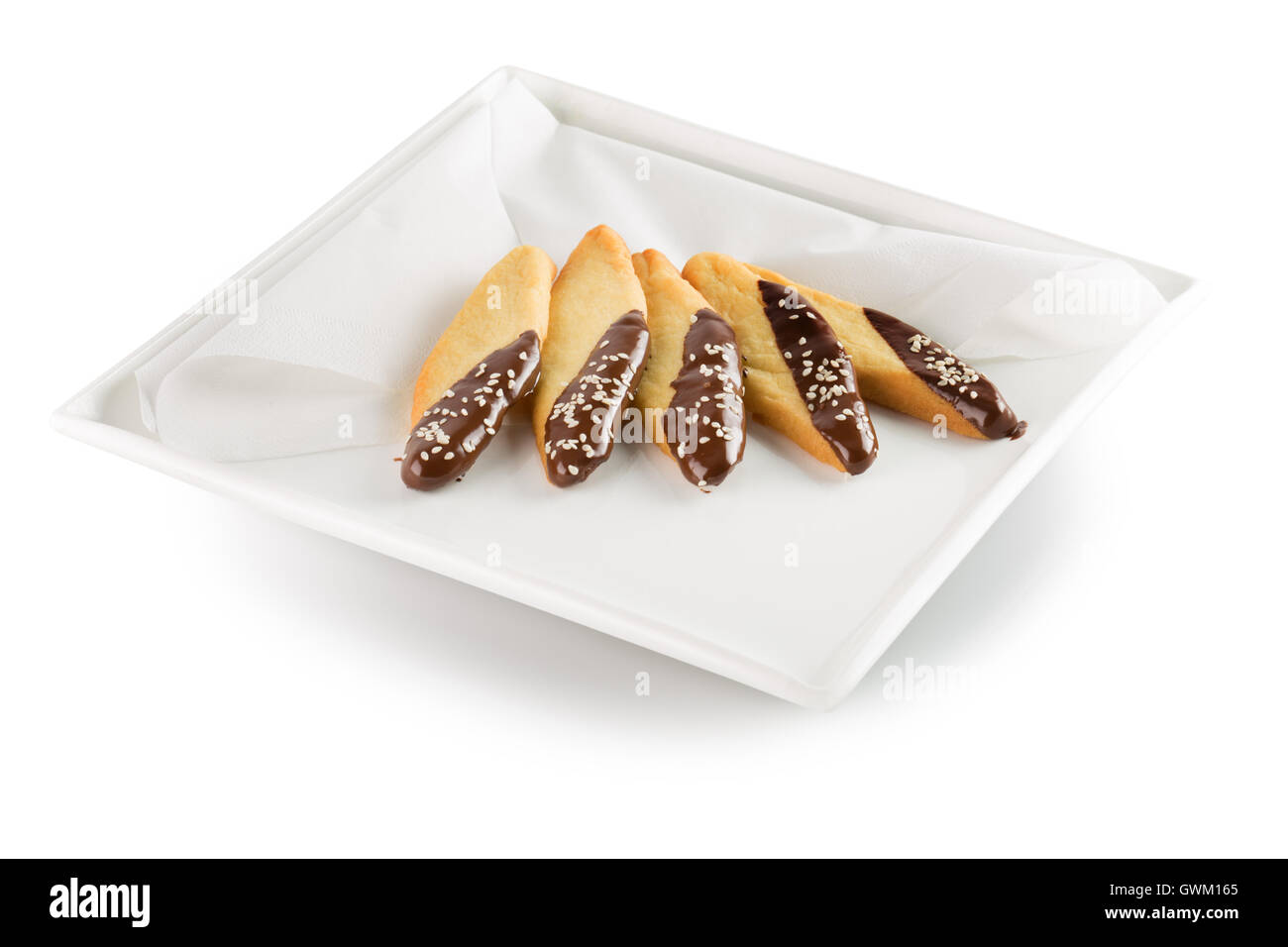 biscuits with chocolate glaze on white plate. Stock Photo