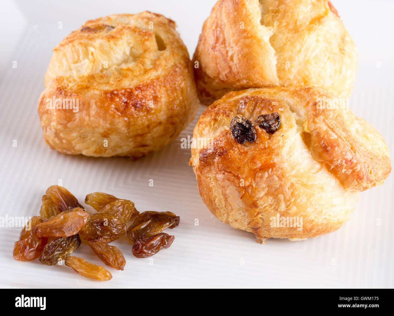puffs with raisins on white plate. Stock Photo
