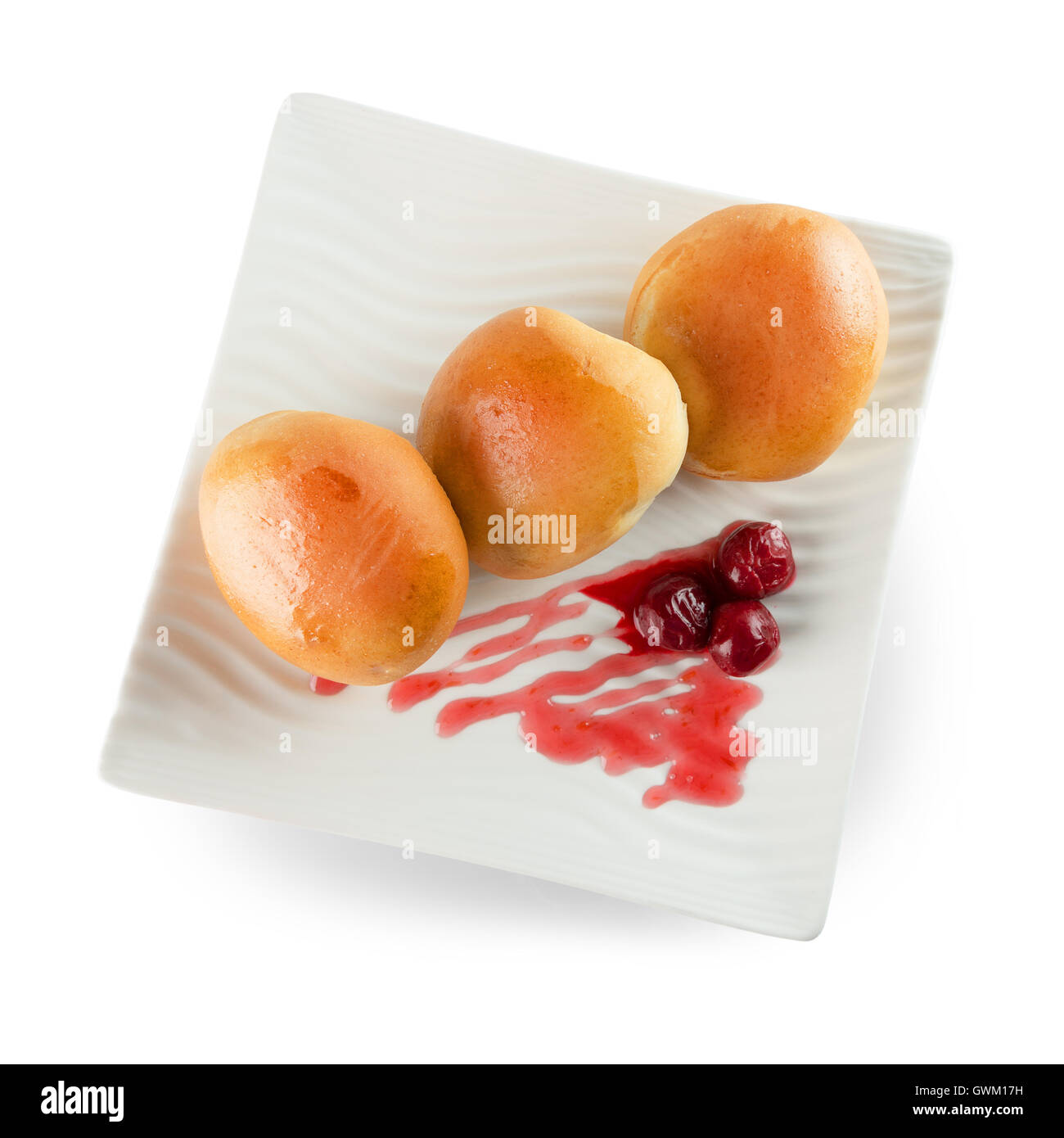 patties with cherries on white plate isolated on the white background. Stock Photo