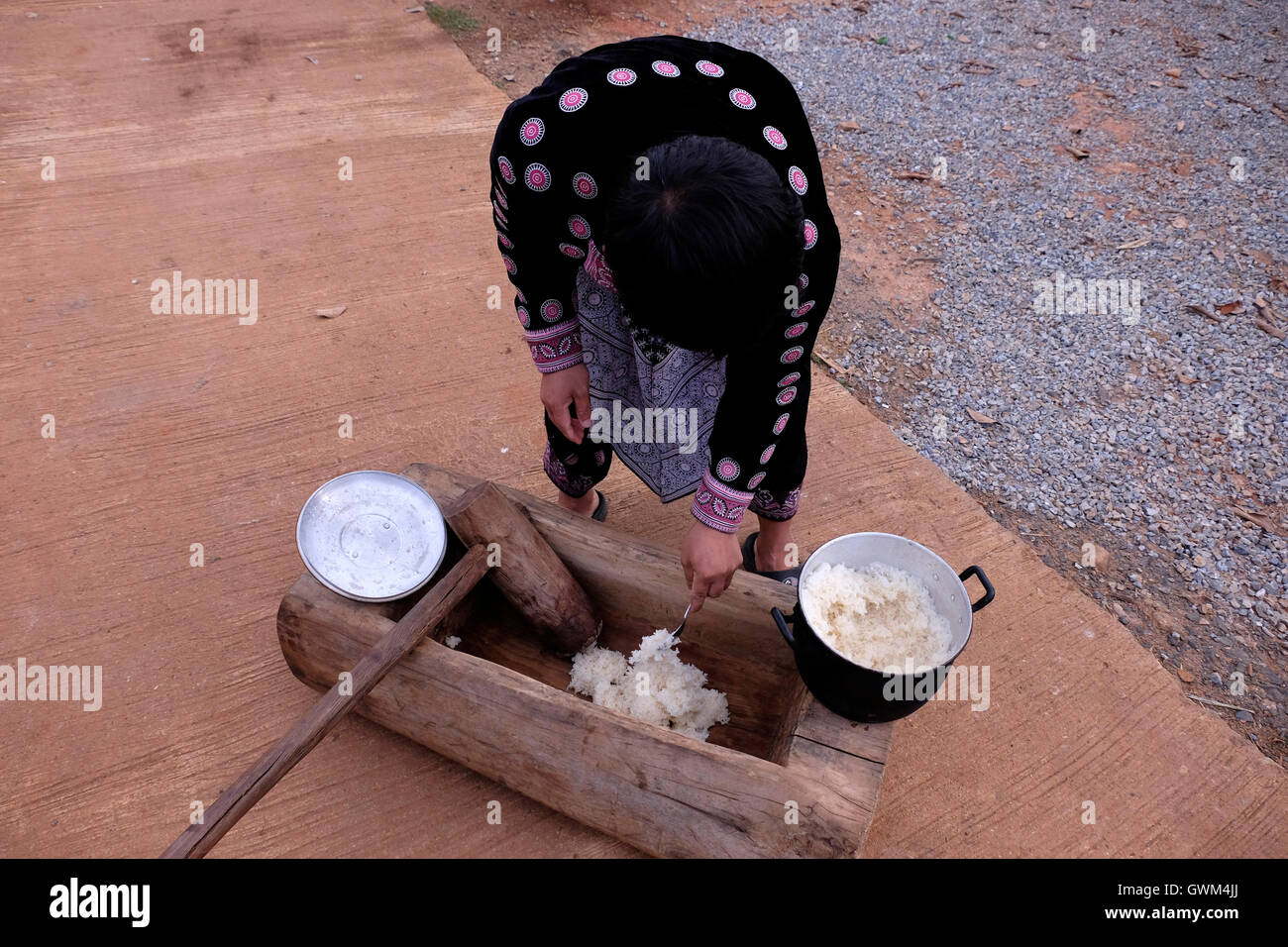 Member of Hmong Tribe in Mae Khi village preparing traditional sticky rice in Mae Rim District, Chiang Mai, northern Thailand. Many Hmong people migrated from Laos to Thailand following the victory of the Pathet Lao in the late 1970s. While some ended up in refugee camps, others settled in mountainous areas becoming one of the ethnic groups referred to as Hill Tribes in Thailand Stock Photo