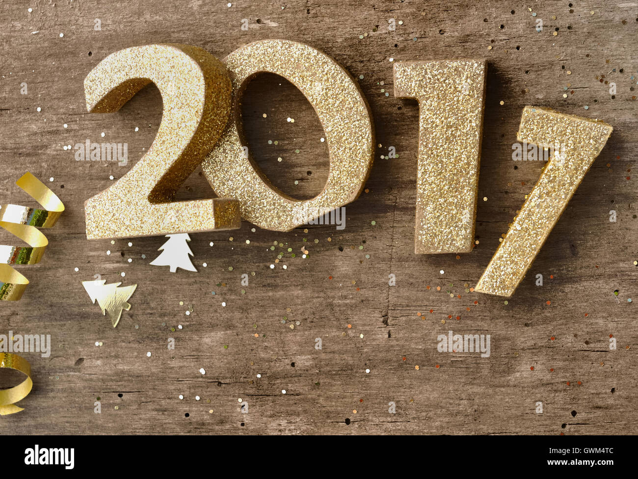 golden 2017 figures with glitter on wooden background Stock Photo
