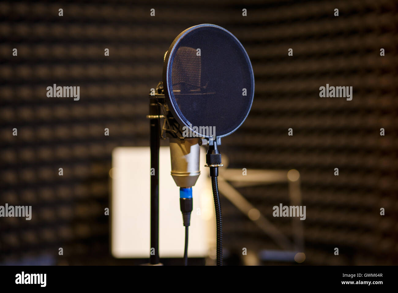 microphone in dark vocal recording room Stock Photo