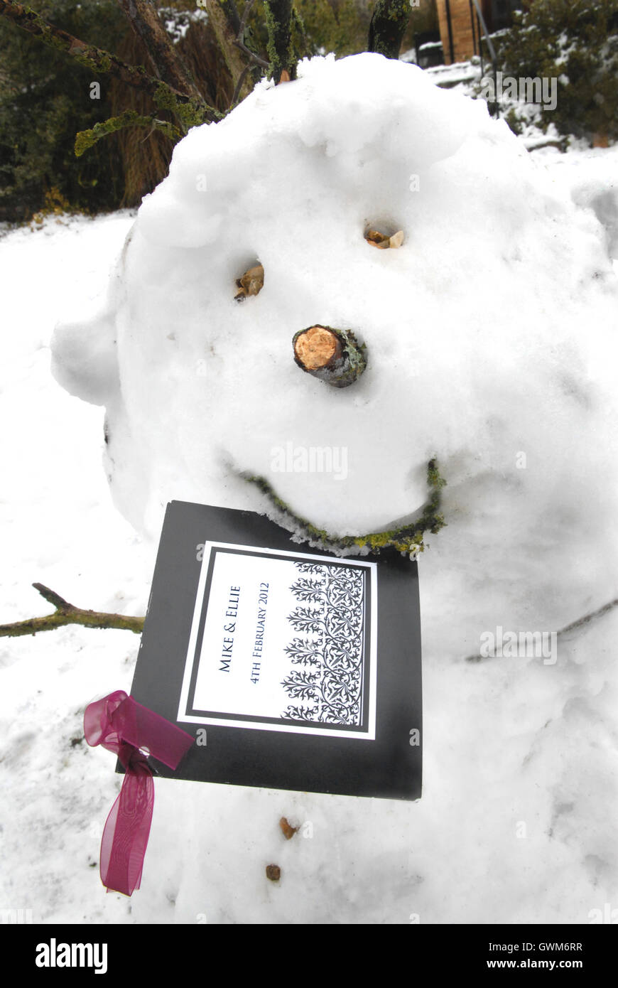 Funny snowman with invite in mouth. Stock Photo