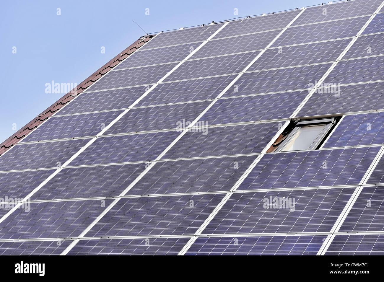 House roof with renewable energy solar and thermal photovoltaic panels Stock Photo