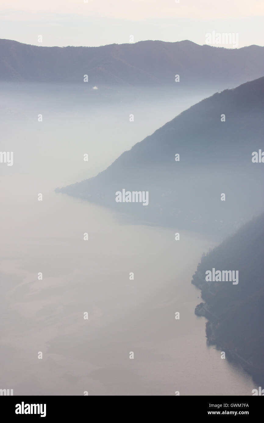 a beautiful misty monochrome picture of the lake and mountains, Italy Stock Photo