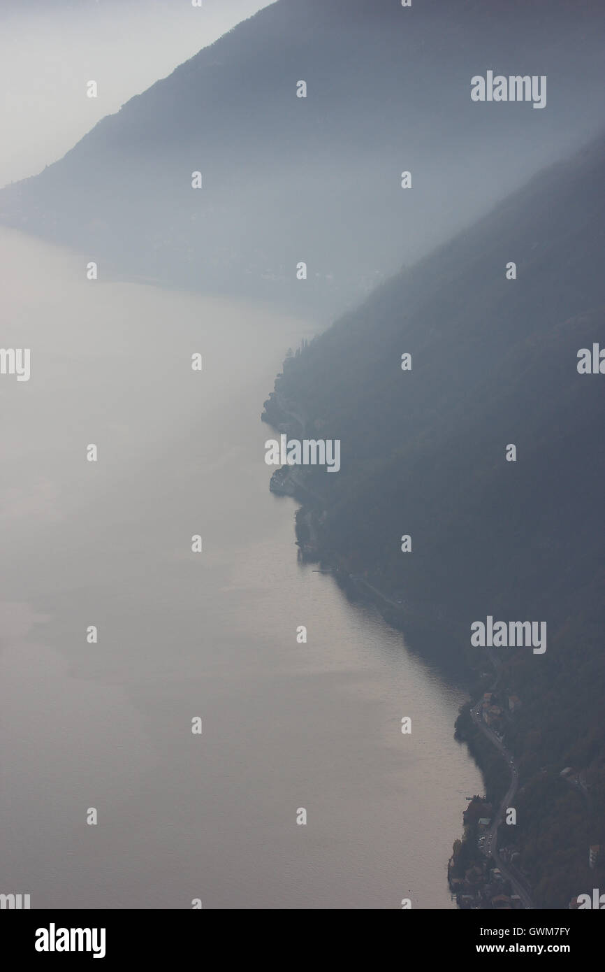 a beautiful misty monochrome picture of the lake and mountains, Italy Stock Photo