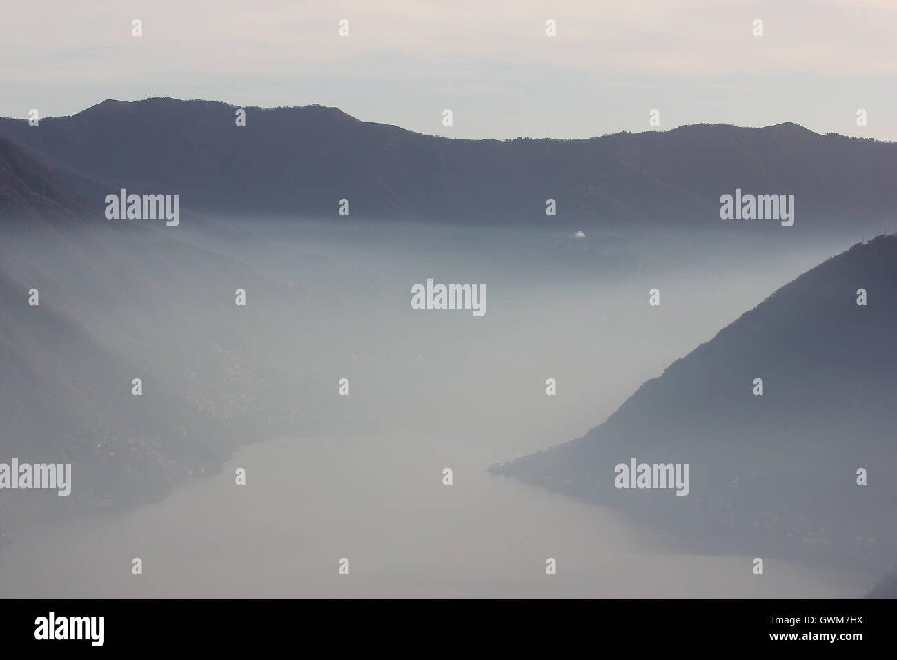 a beautiful misty monochrome picture of the lake and mountains, Italy Stock Photo