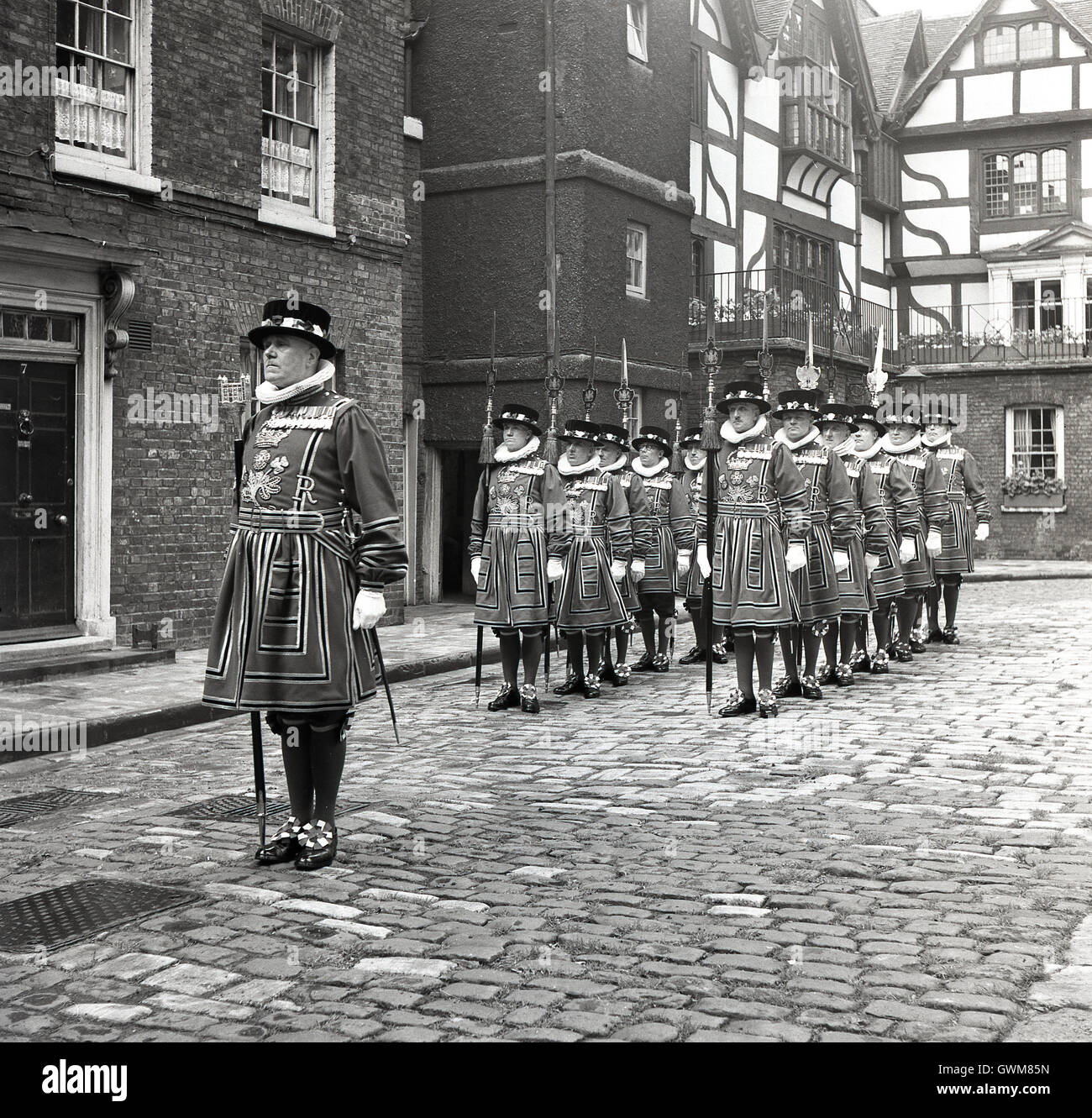 1950s historical, line-up of Yeomen Warders of Her Majesty's Royal Palace and Fortress the Tower of London, popularly known as Beefeaters. Stock Photo