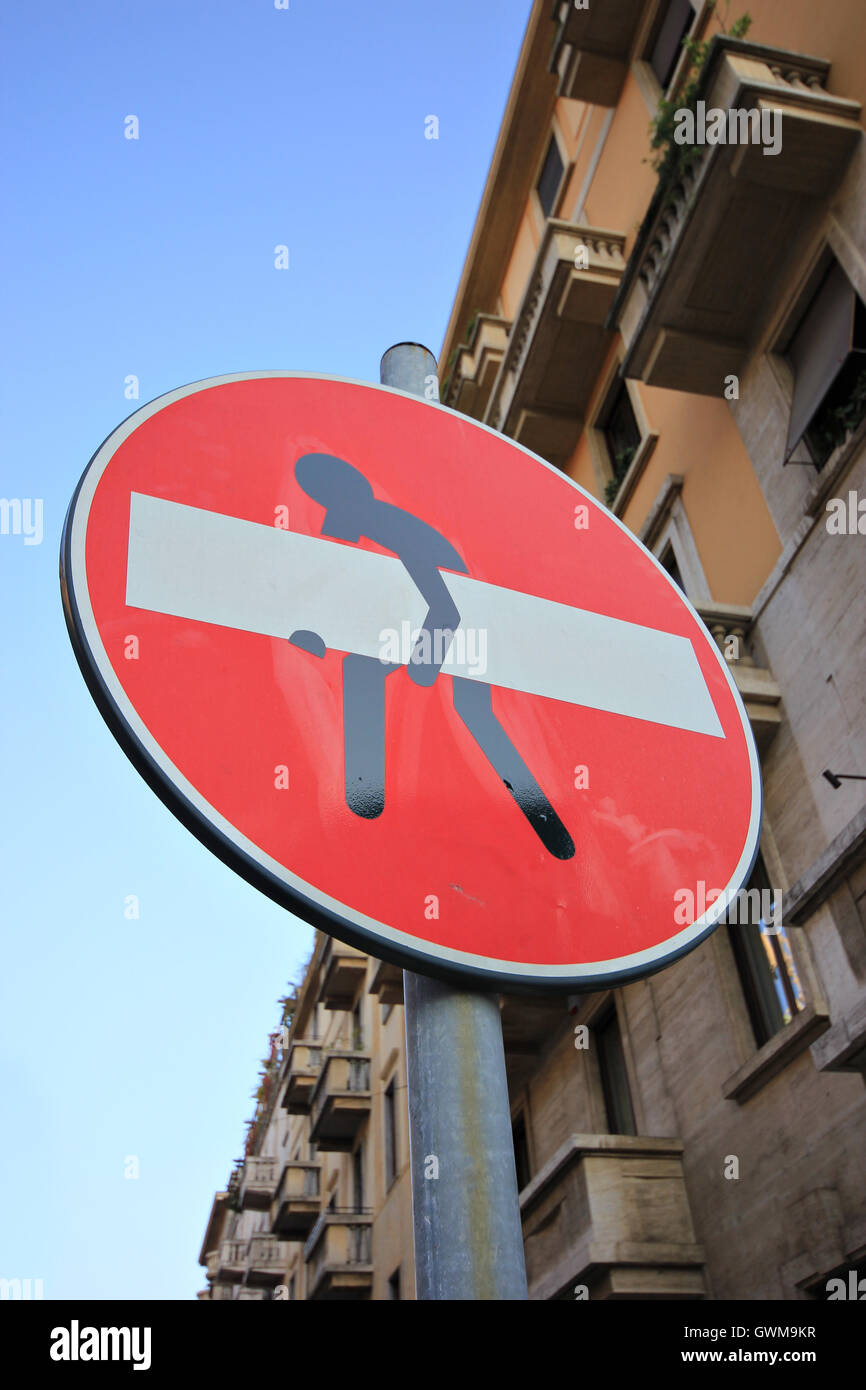 no entry sign with figure lifting it, street art, Milan, Italy Stock Photo