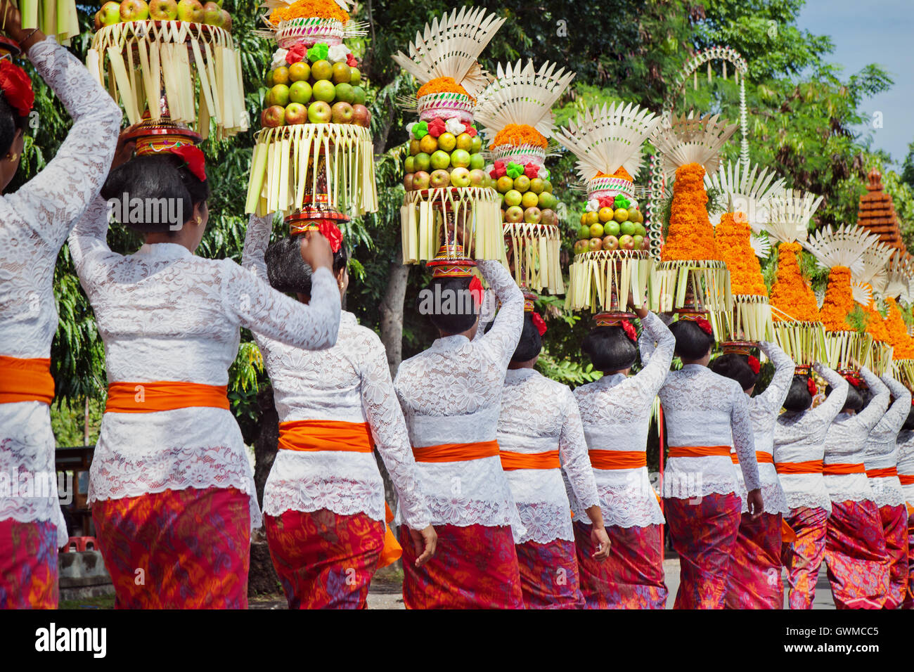 Procession of Balinese women in traditional costumes - sarong, carry