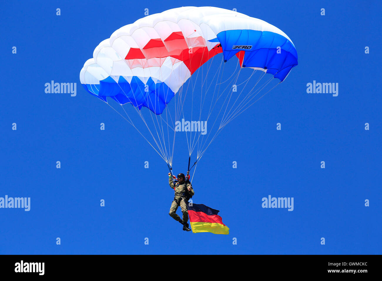 parachutist with German flag in the air at SIAF airshow in Sliac, Slovakia Stock Photo