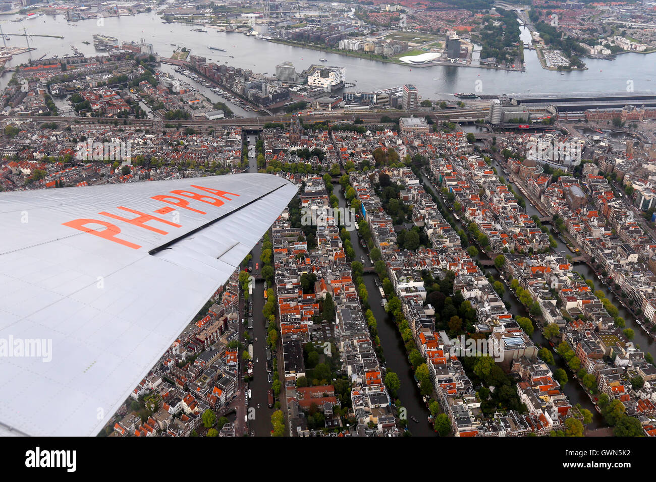 DDA Classic Flights Douglas DC-3 orbits over the city of Amsterdam. Stock Photo