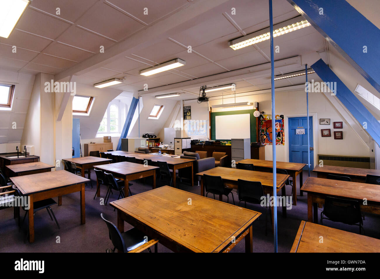Old wooden desks in a traditional classroom Stock Photo