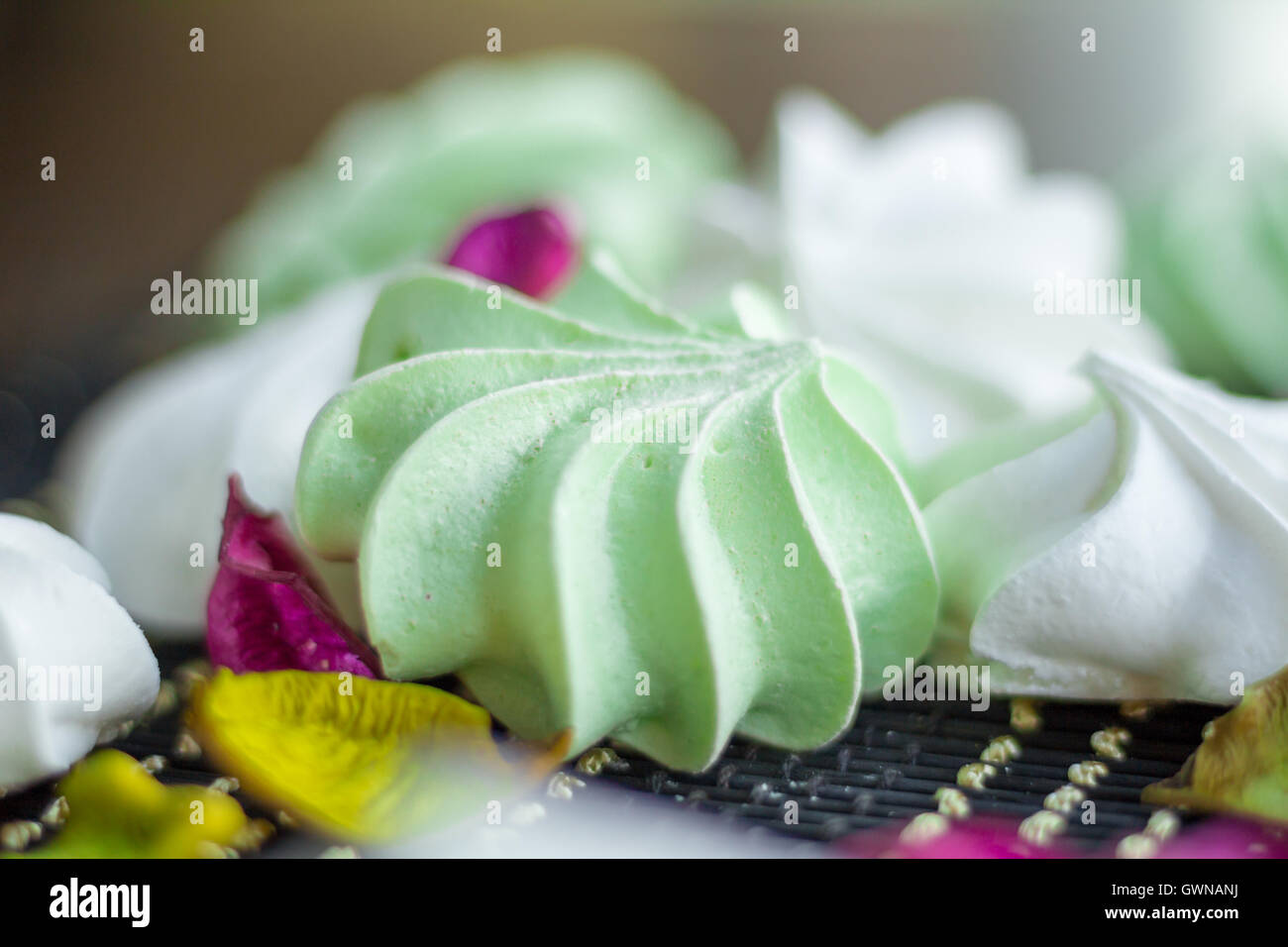 White and green marshmallow dessert composition on black background Stock Photo