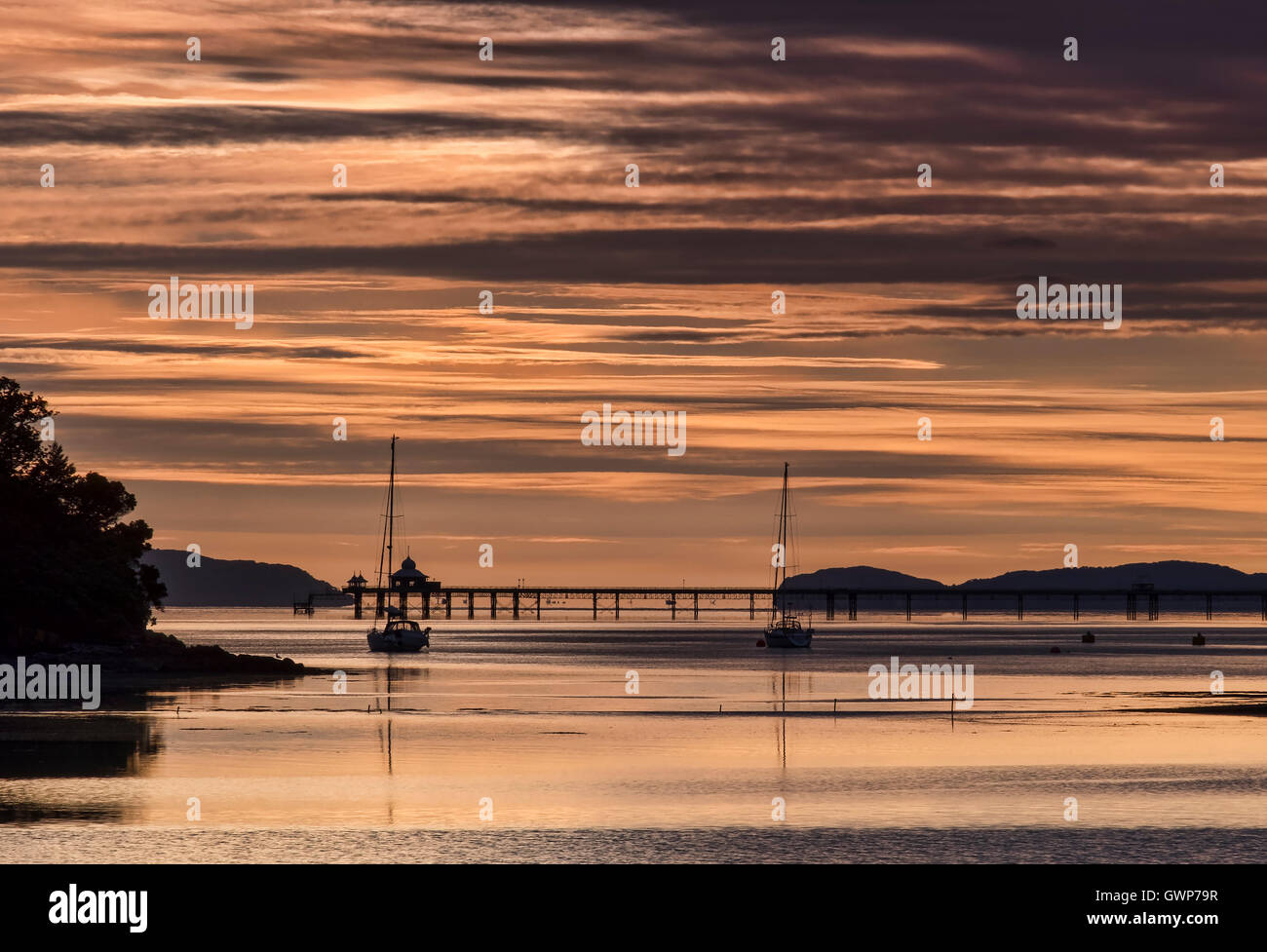 Sunrise Over The Menai Straits, Bangor Pier & The Great Orme, Anglesey, North Wales, UK Stock Photo