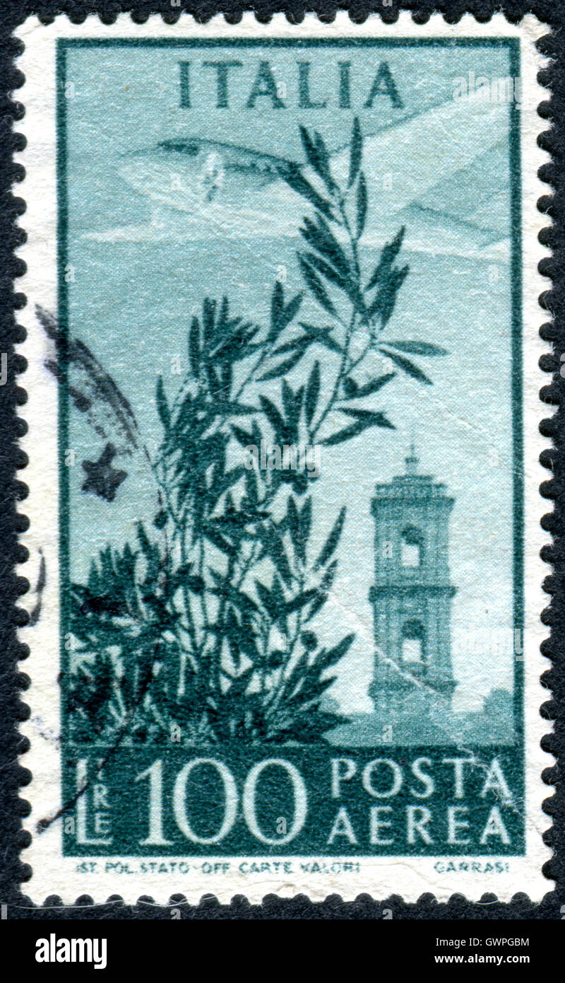Postage stamp printed in Italy, shows aircraft Douglac DC-3 'Dakota' over Capitol Bell Tower and the olive branch. Stock Photo
