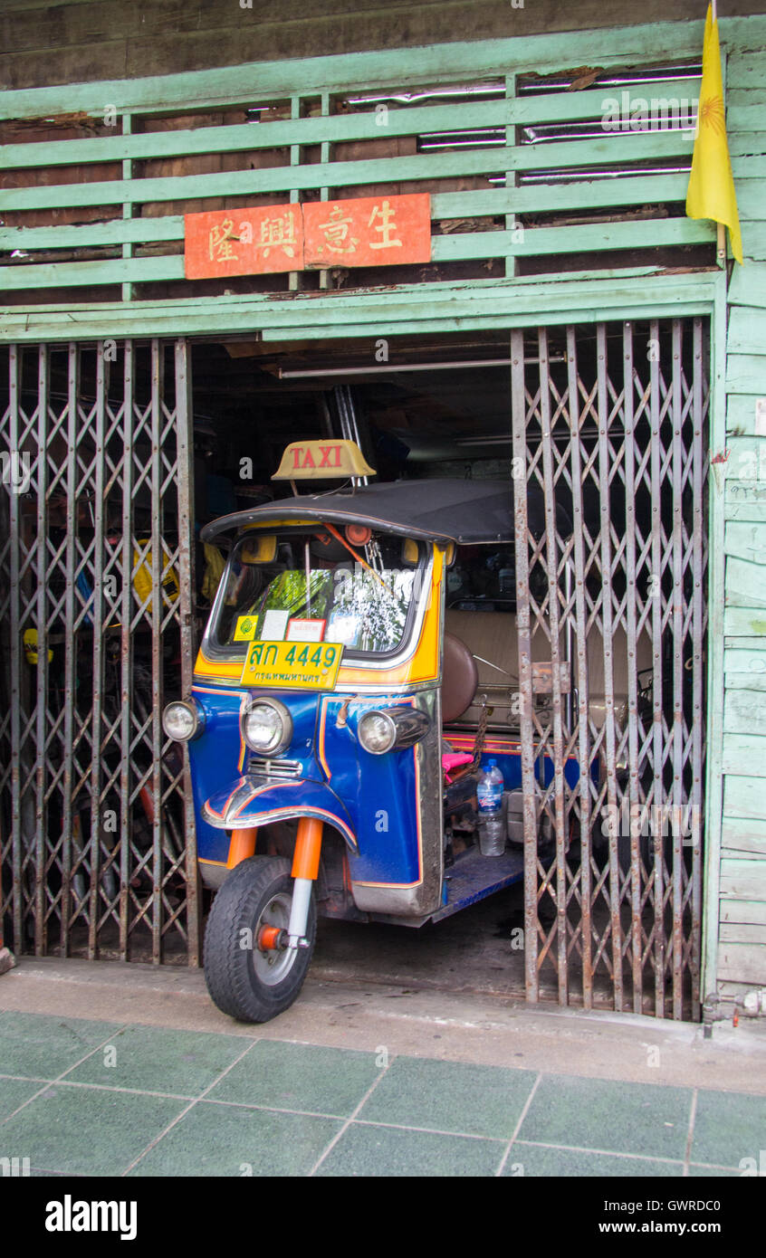 Tuk tuk in a garage in Bangkok, Thailand Stock Photo